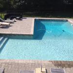 "L"-shaped pool with full length step in shallow end and auto-vacuum cleaning while you watch.